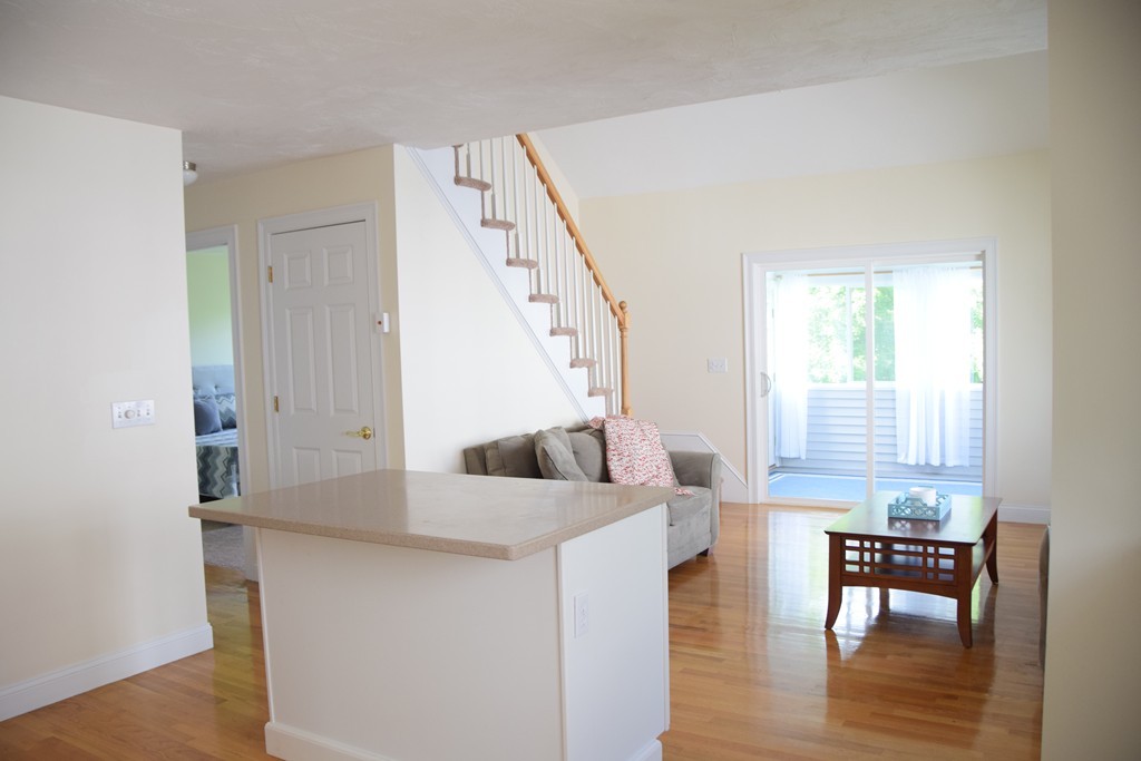102 Summer Road, Unit 102 Boxborough, MA 01719 - Photo 8 of 17 a living room with furniture and a table