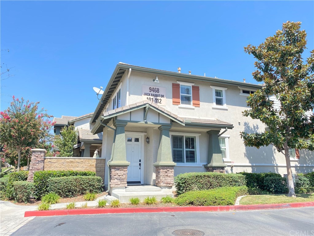 9468 Jack Rabbit Drive, Unit 112 Rancho Cucamonga, CA 91730 - Photo 1 of 1 a front view of a house with a yard