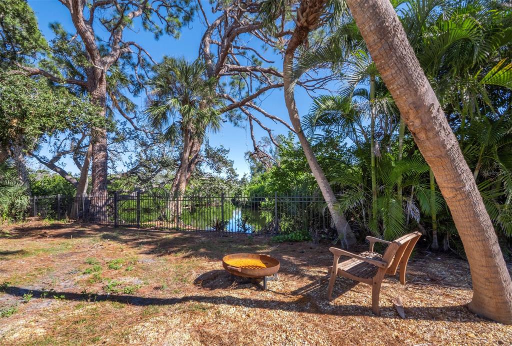 7233 Pine Needle Road Sarasota, FL 34242 - Photo 13 of 49 a backyard of a house with table and chairs