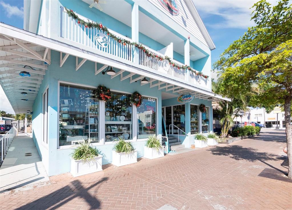 7233 Pine Needle Road Sarasota, FL 34242 - Photo 40 of 49 a view of a building with a large window and a tree