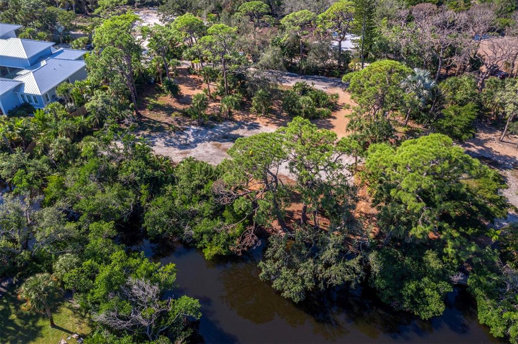 7233 Pine Needle Road Sarasota, FL 34242 - Photo 7 of 49 an aerial view of residential house with outdoor space and trees all around