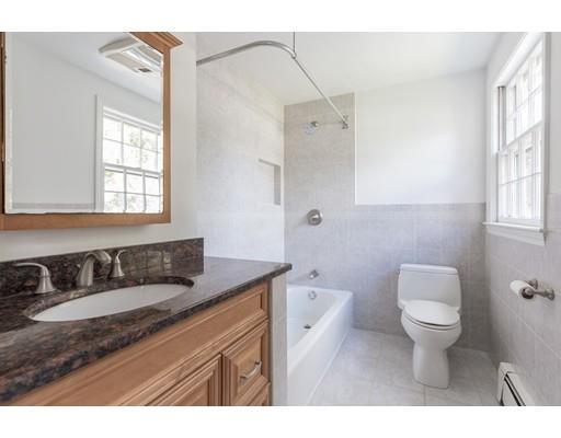25 Twitchell Street Wellesley, MA 02482 - Photo 14 of 23 a bathroom with a granite countertop sink a toilet a mirror and window