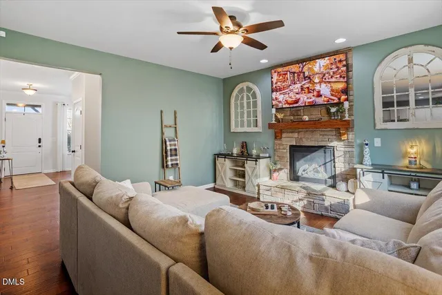 a living room with furniture a fireplace and a flat screen tv
