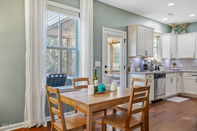 a kitchen with a table chairs stove and cabinets