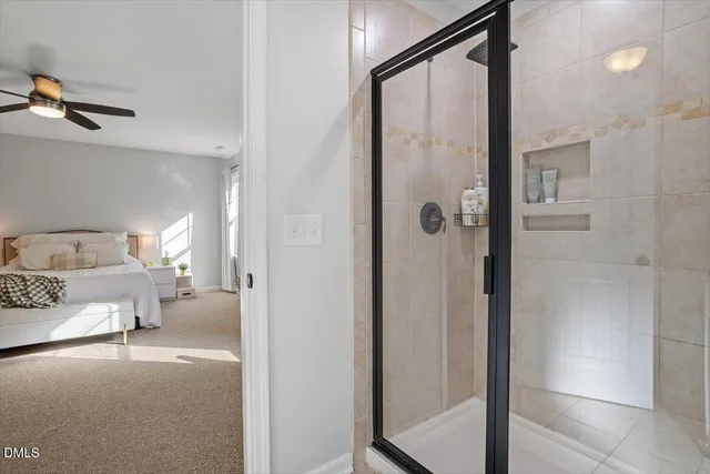 a en suite bathroom with a shower and mirror