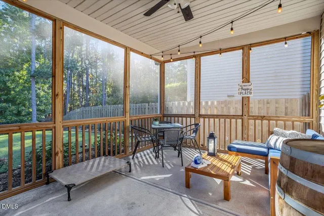 a balcony with furniture and a potted plant