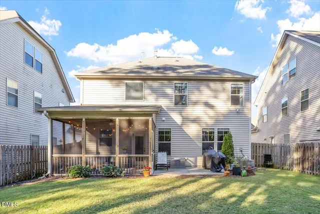a front view of a house with a garden and plants
