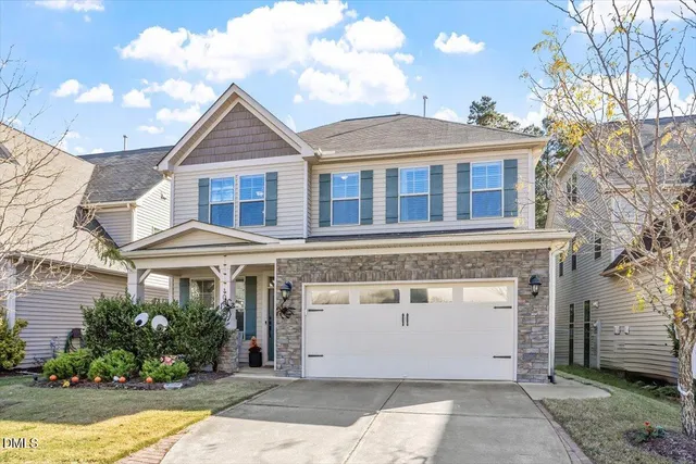 a front view of a house with a yard and garage