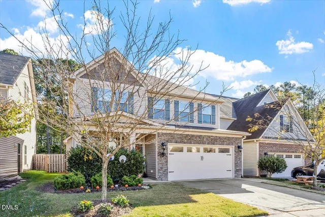 a view of a white building among the street with palm trees