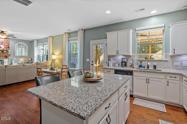 a kitchen with sink and view living room