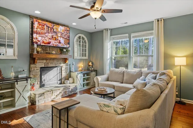 a living room with furniture a large window and a fireplace