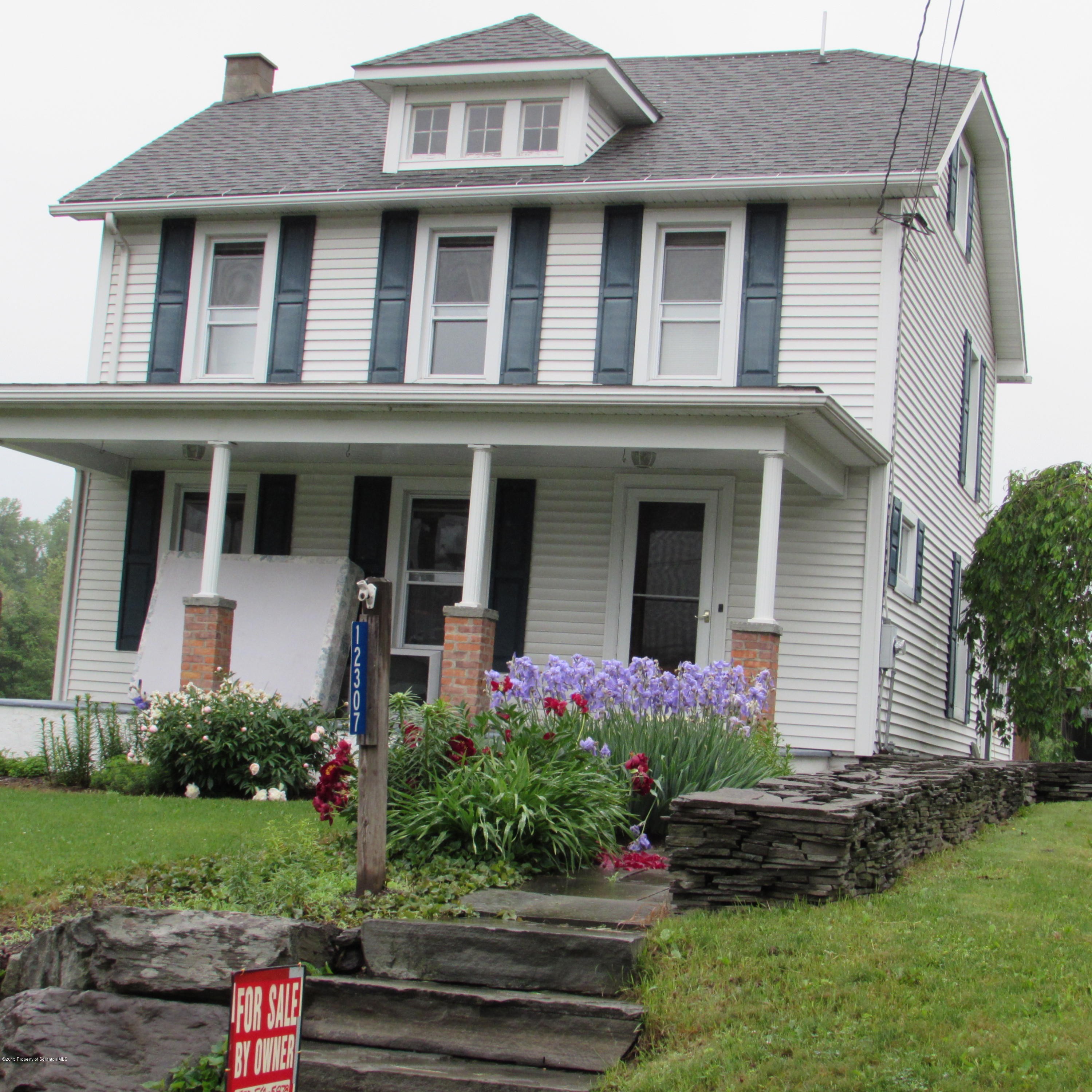 12307 Strickland Hill Road Springville, PA 18844 - Photo 1 of 18 a front view of a house with a yard