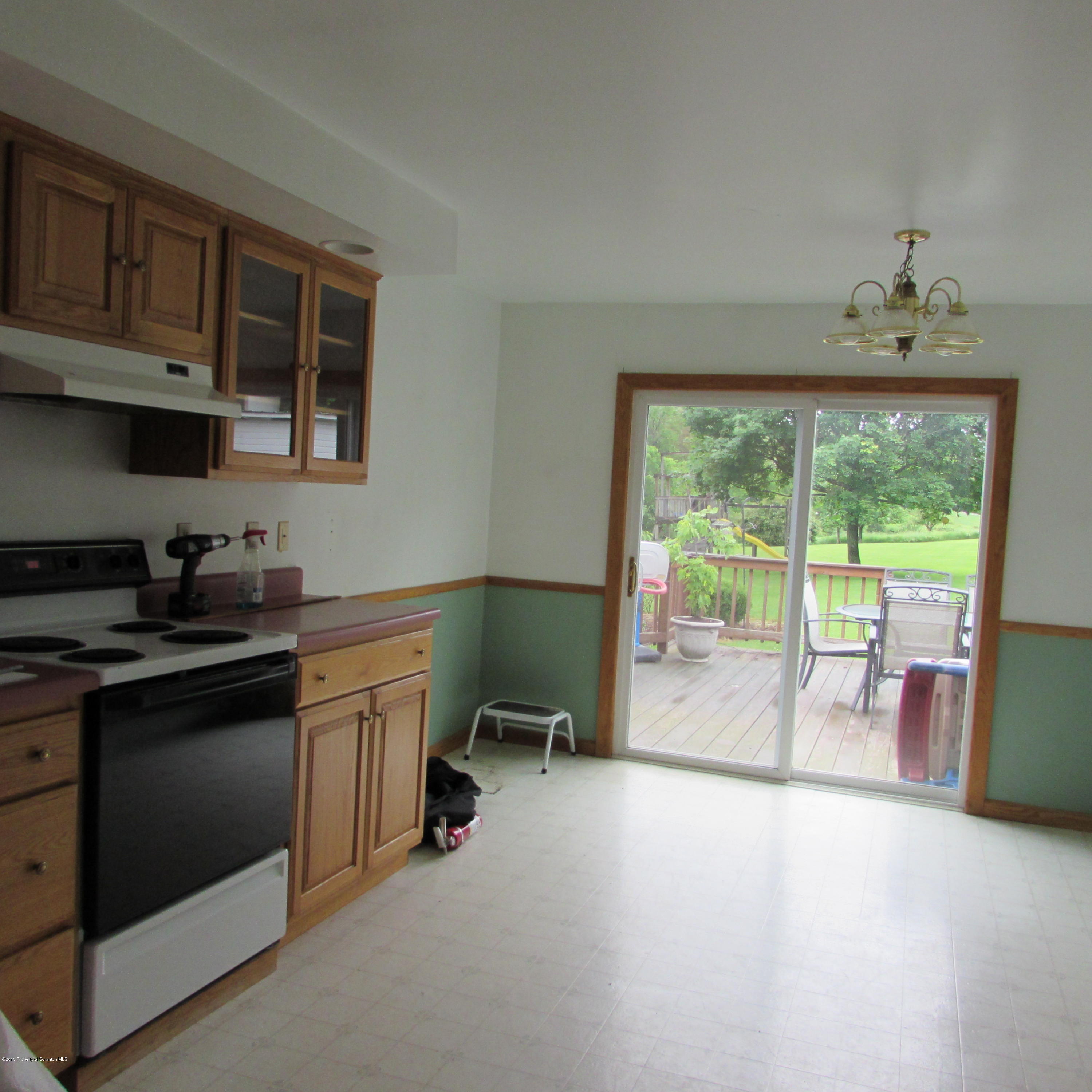 12307 Strickland Hill Road Springville, PA 18844 - Photo 8 of 18 a kitchen with a sink stove and cabinets