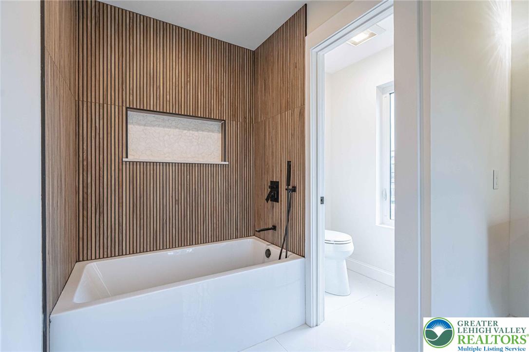 300 Witmer Road Horsham, PA 19044 - Photo 35 of 50 a bathroom with a bathtub and a toilet