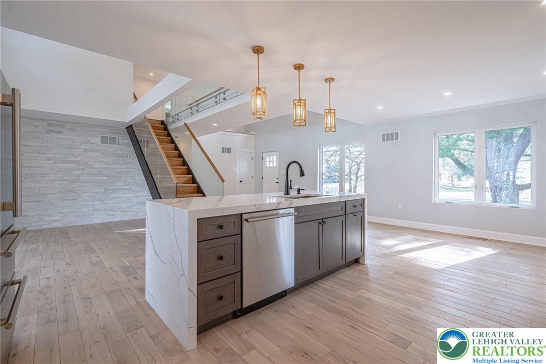 300 Witmer Road Horsham, PA 19044 - Photo 8 of 50 a kitchen with stainless steel appliances granite countertop a sink a stove and a wooden floors