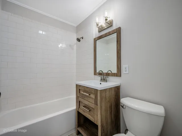 a bathroom with a toilet a sink and bathtub