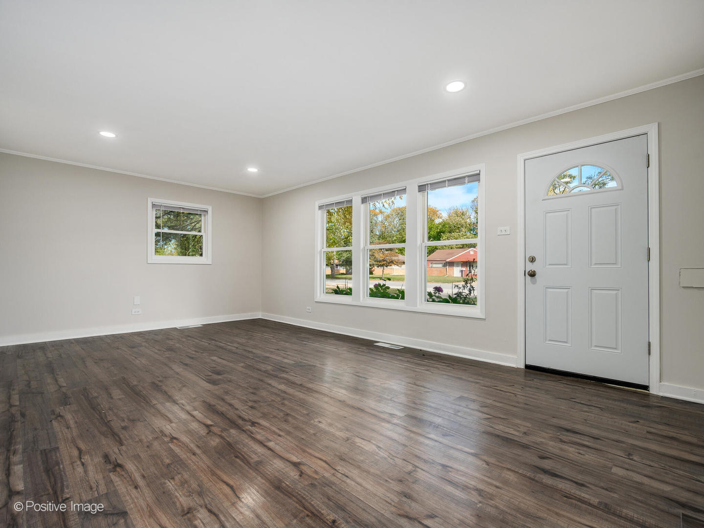353 Blackhawk Drive Park Forest, IL 60466 - Photo 3 of 15 an empty room with wooden floor and windows