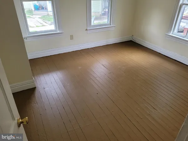 a view of room with window and hardwood floor