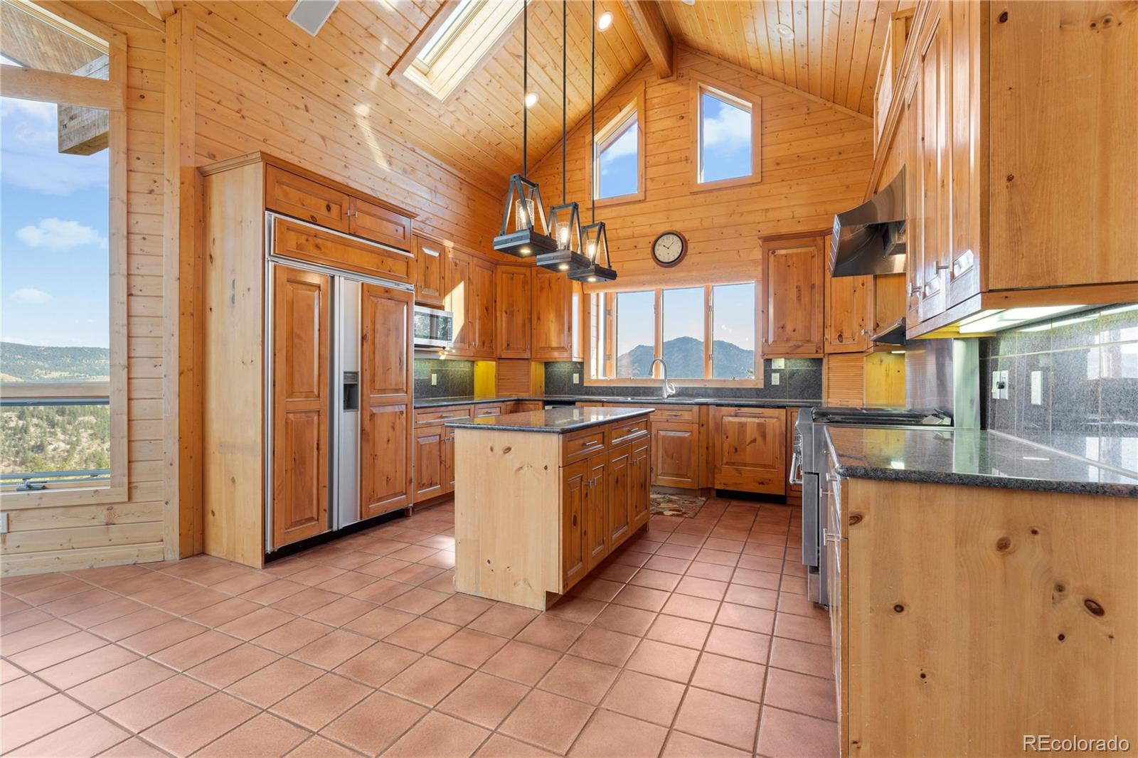 2489 Gross Dam Road Golden, CO 80403 - Photo 16 of 47 a kitchen with stainless steel appliances granite countertop a sink and cabinets