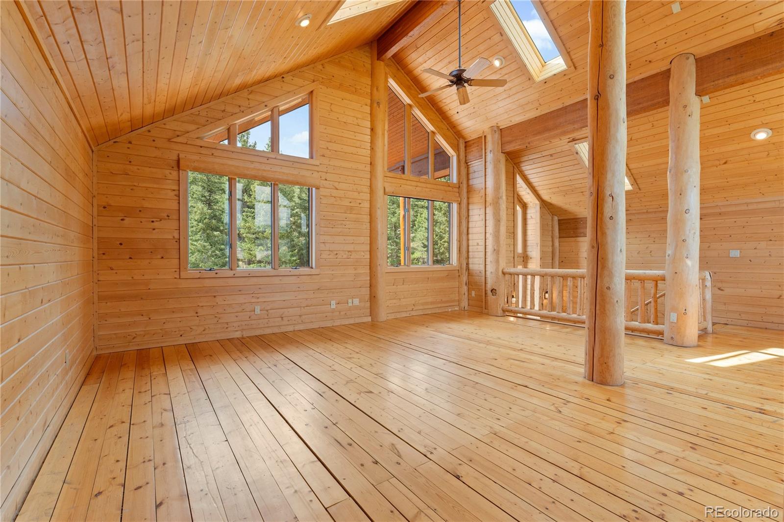 2489 Gross Dam Road Golden, CO 80403 - Photo 21 of 47 a view of an empty room with wooden floor and a window