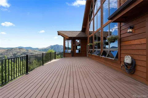 a view of a house with a wooden deck