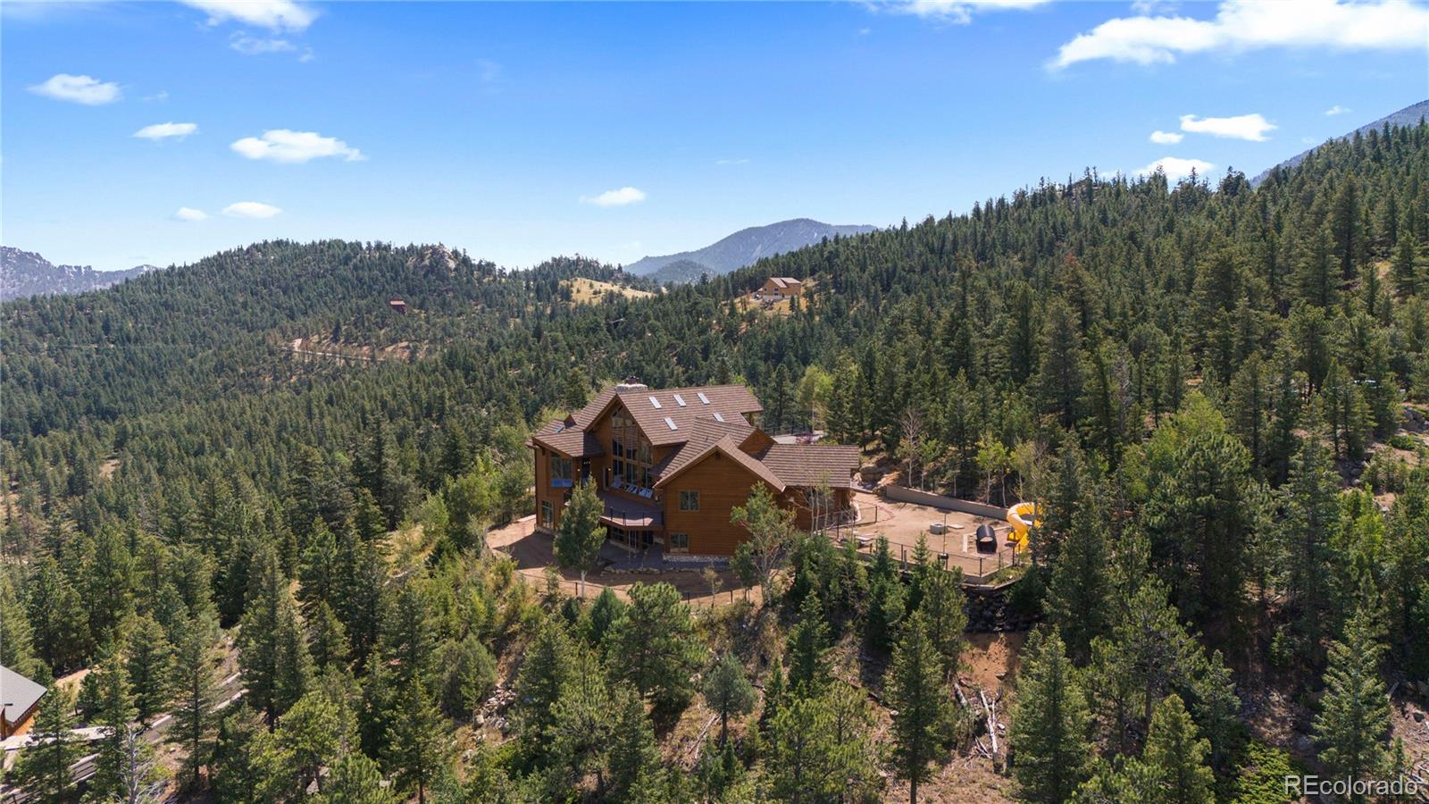 2489 Gross Dam Road Golden, CO 80403 - Photo 44 of 47 a view of a house with a mountain and a forest