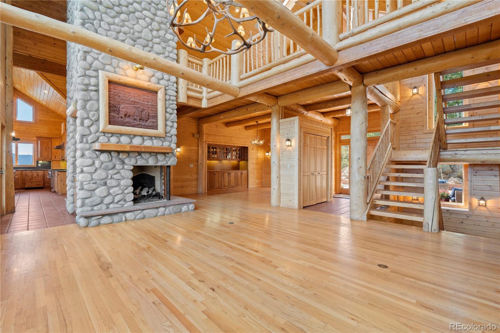 2489 Gross Dam Road Golden, CO 80403 - Photo 5 of 47 a view of an entryway with wooden floor fire place and a front door