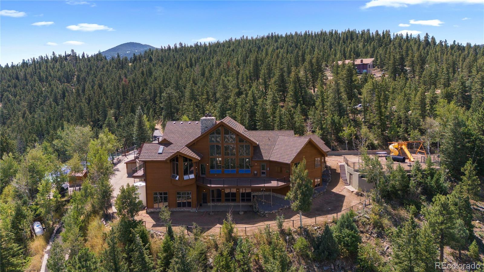2489 Gross Dam Road Golden, CO 80403 - Photo 6 of 47 a view of a house with a yard and a wooden deck