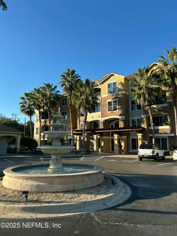 a front view of a building with a garden