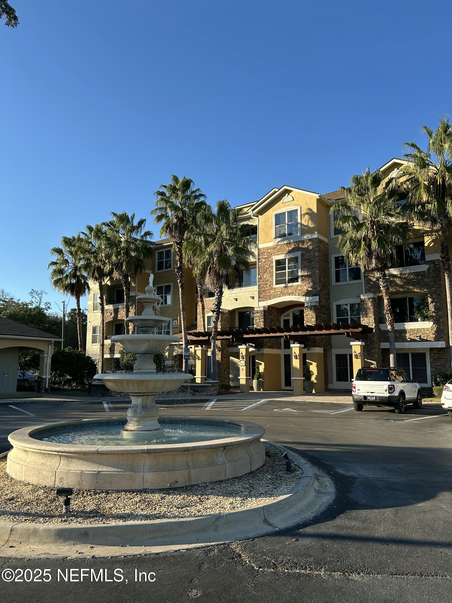 a front view of a building with a garden
