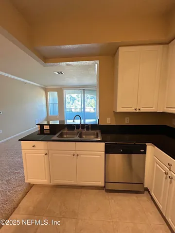 a view of an empty room with glass door