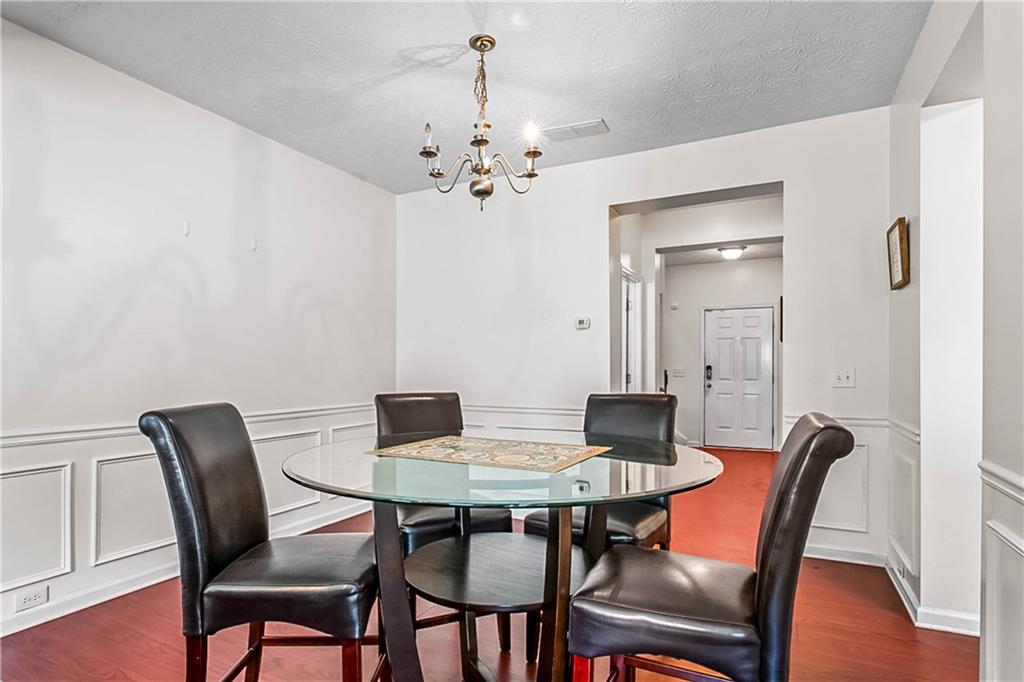 2555 Flat Shoals Road, Unit 2006 Atlanta, GA 30349 - Photo 11 of 29 a view of a dining room with furniture and wooden floor