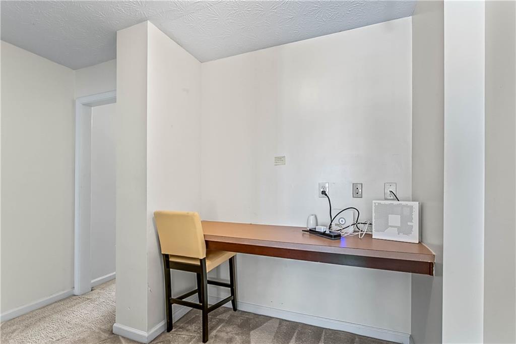 2555 Flat Shoals Road, Unit 2006 Atlanta, GA 30349 - Photo 21 of 29 a view of a room with a table and chairs