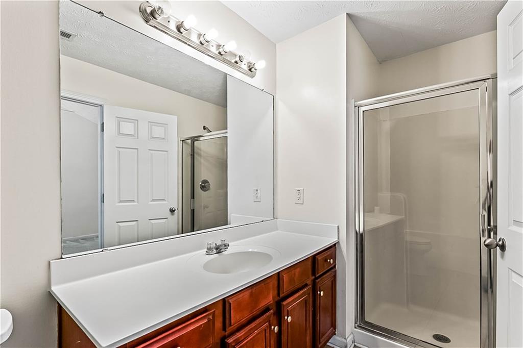 2555 Flat Shoals Road, Unit 2006 Atlanta, GA 30349 - Photo 24 of 29 a bathroom with a sink and a mirror