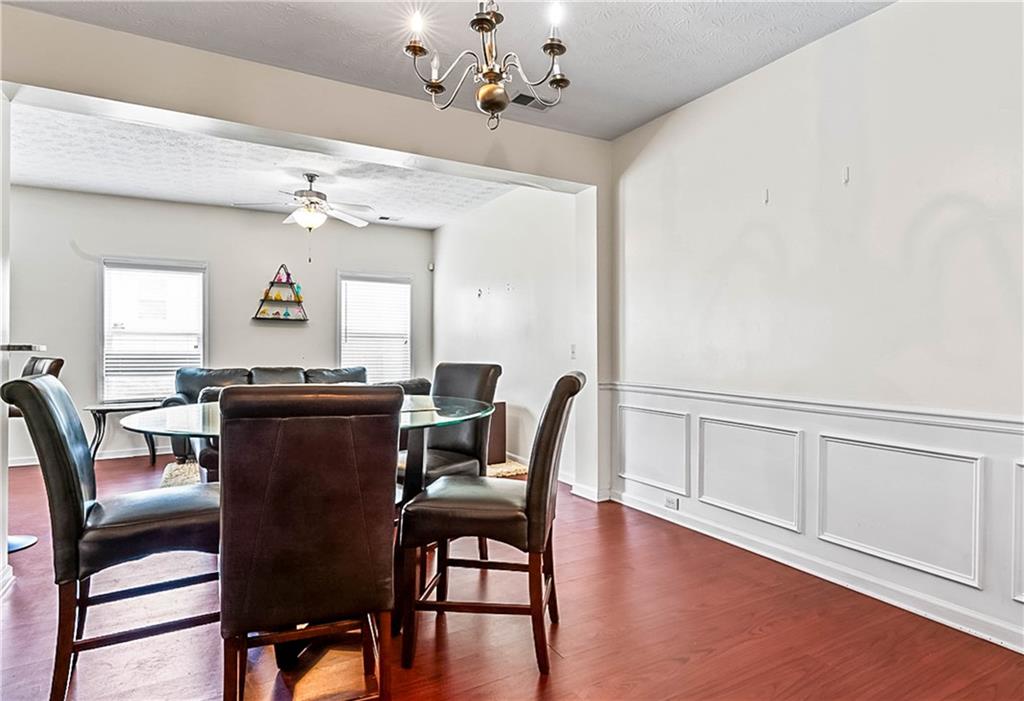 2555 Flat Shoals Road, Unit 2006 Atlanta, GA 30349 - Photo 8 of 29 a view of a dining room with furniture and a chandelier