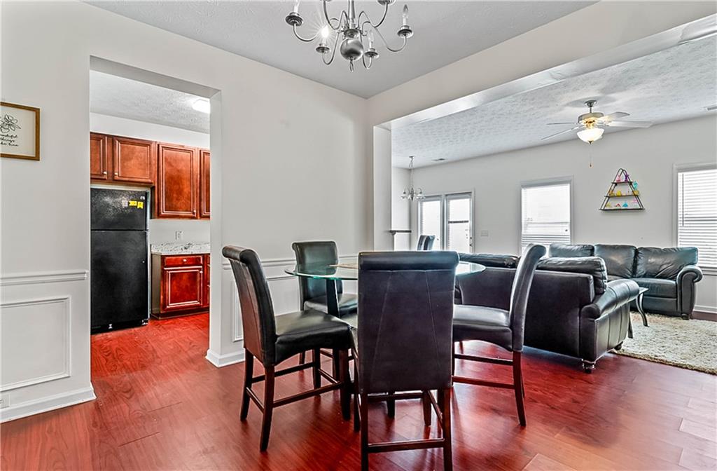 2555 Flat Shoals Road, Unit 2006 Atlanta, GA 30349 - Photo 9 of 29 a view of a dining room with furniture window and wooden floor