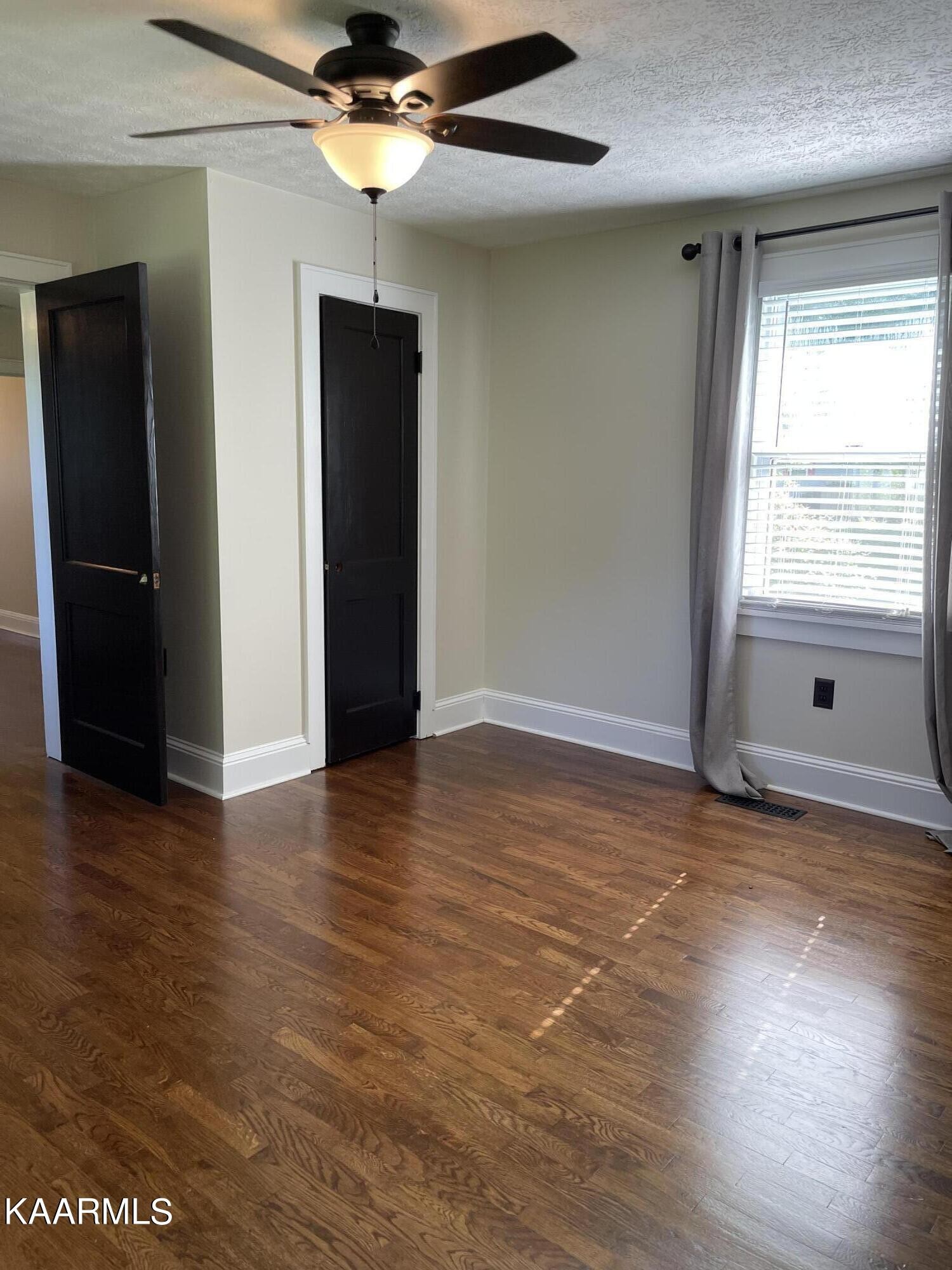 7522 Clapps Chapel Road Corryton, TN 37721 - Photo 11 of 12 an empty room with wooden floor and windows