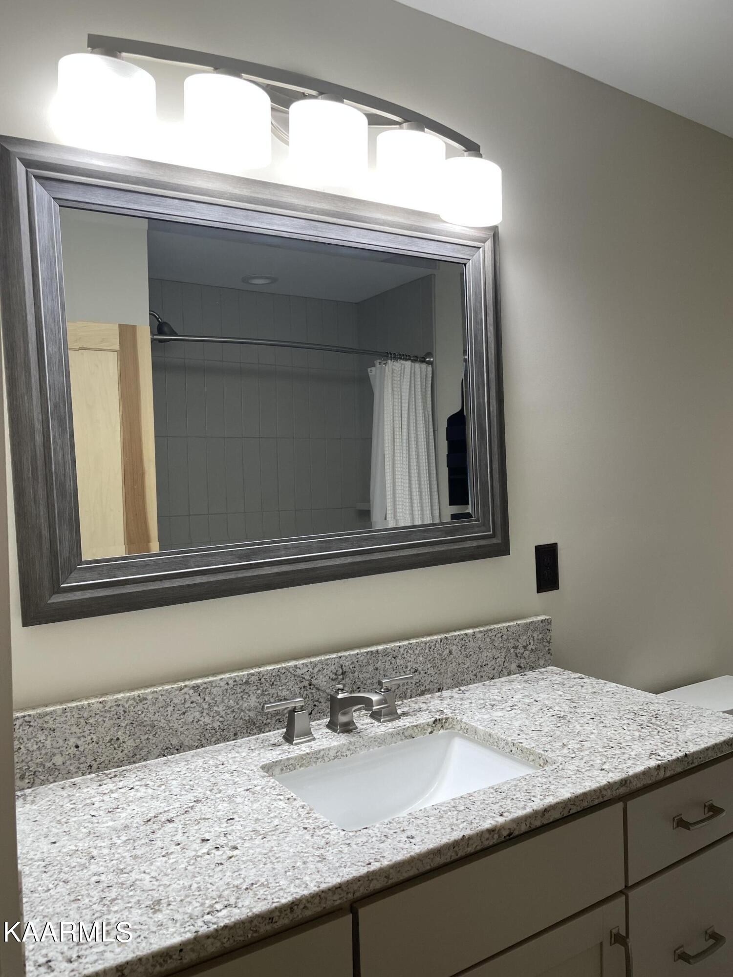 7522 Clapps Chapel Road Corryton, TN 37721 - Photo 12 of 12 a bathroom with a granite countertop sink and a mirror