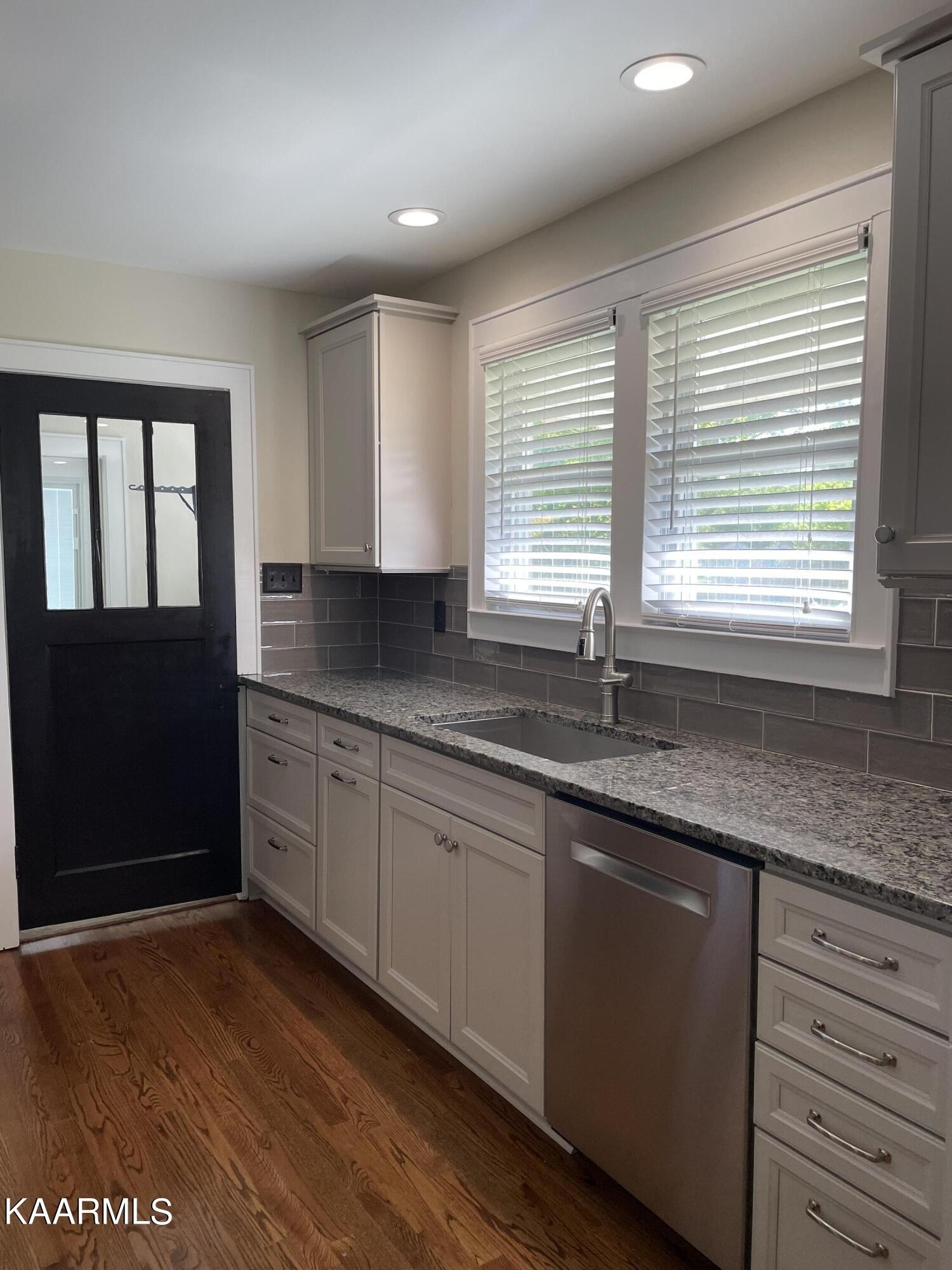 7522 Clapps Chapel Road Corryton, TN 37721 - Photo 9 of 12 a kitchen with granite countertop wooden cabinets a sink and a window