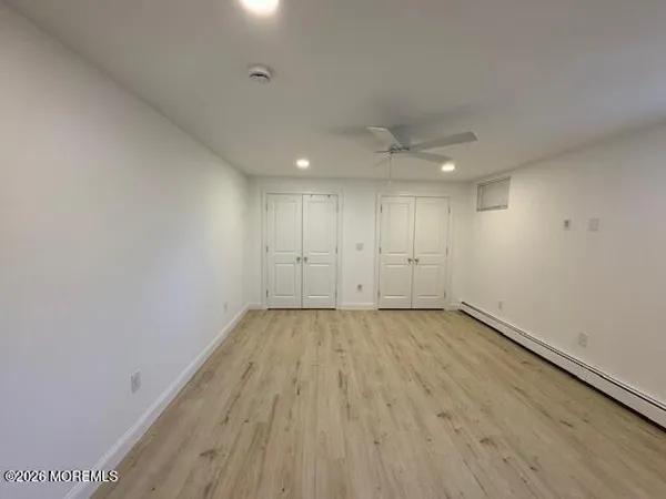 a view of an empty room and wooden floor