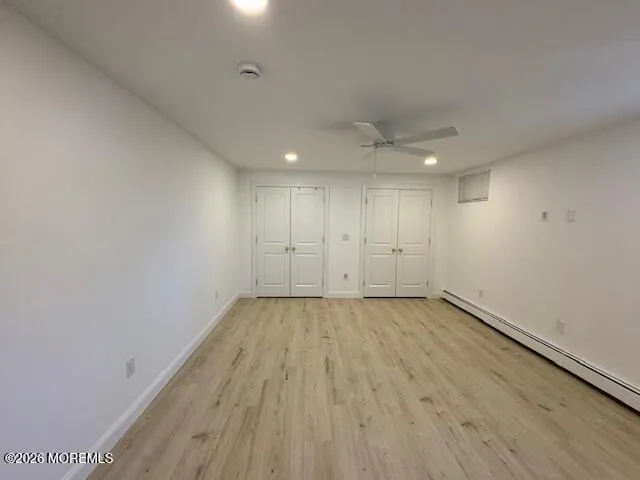 a view of an empty room and wooden floor