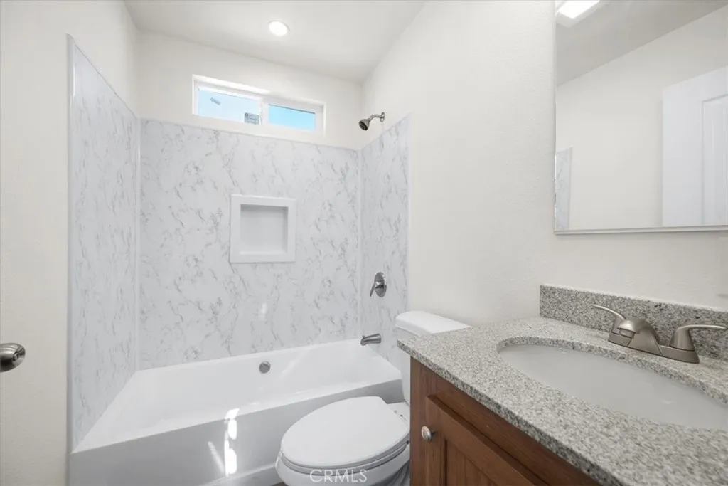 1255 Orcutt Road, Unit B27 San Luis Obispo, CA 93401 - Photo 22 of 24 a bathroom with a granite countertop sink a toilet and bathtub