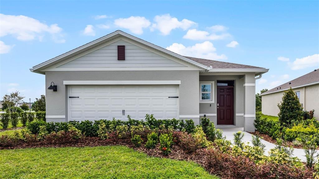 a front view of house with yard and trees