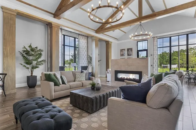 a living room with furniture a fireplace and wooden floors