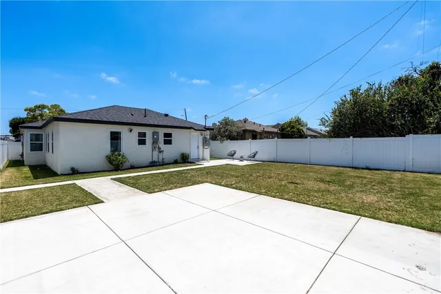 a view of a house with a yard and a garage
