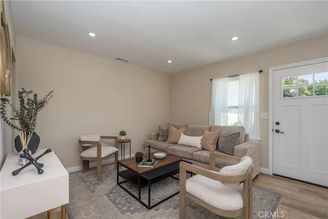 a living room with furniture and a potted plant