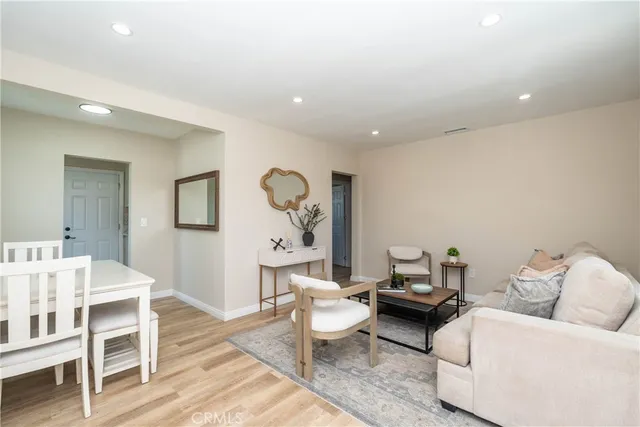 a living room with furniture and a wooden floor