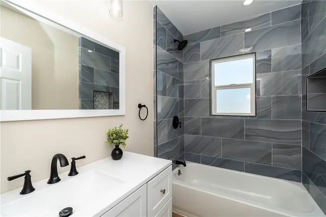 a bathroom with a sink a bathtub and a shower