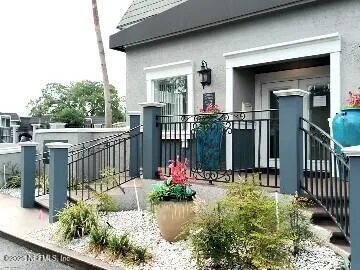 a view of a house with wooden floor fence and a porch