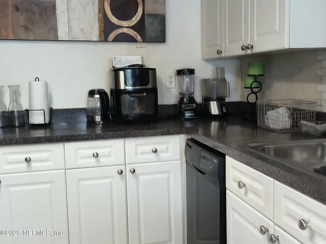 a kitchen with stainless steel appliances granite countertop a sink a stove and cabinets